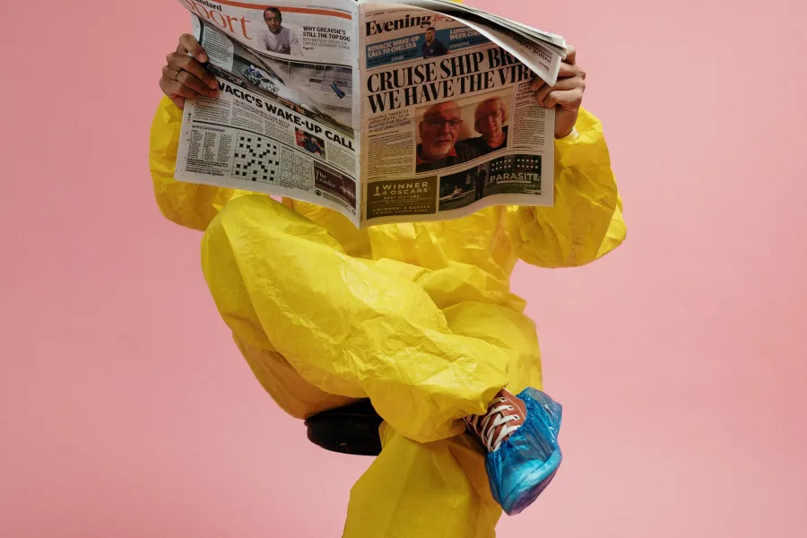 man-in-yellow-protective-suit-holding-a-newspaper-3951350.jpg